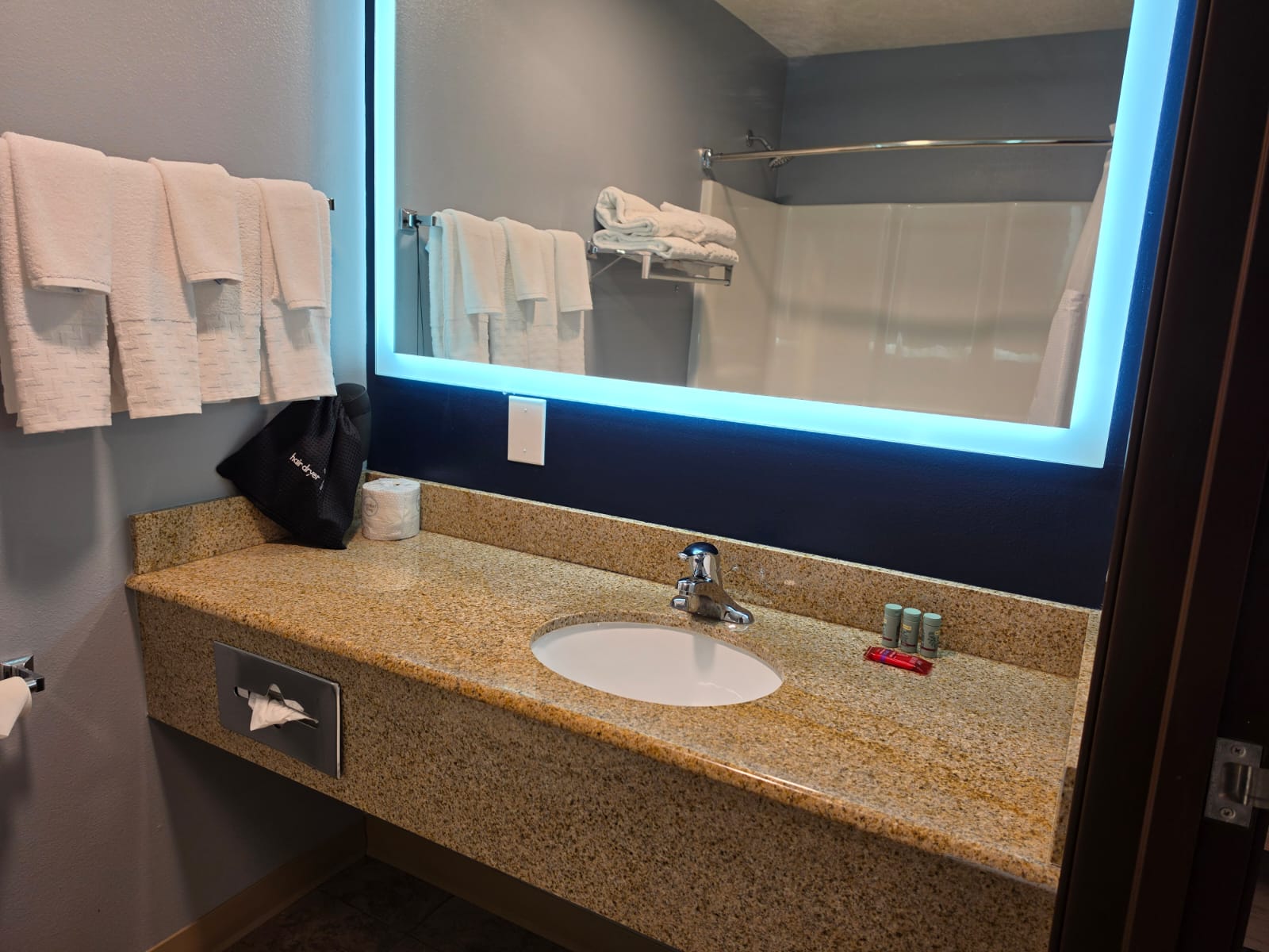Hotel bathroom vanity with granite counter and backlit mirror — Best Western Vernal Inn, Vernal Utah