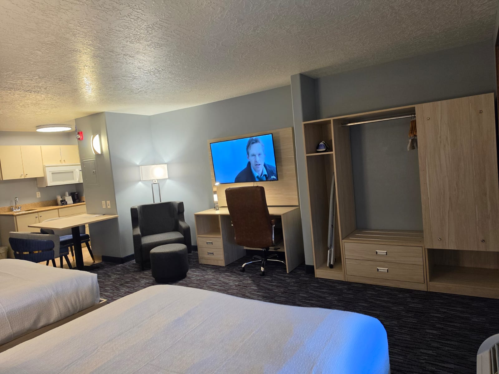 Kitchenette, dining table, seating area, desk and closet in a Studio Two Queen — Best Western Vernal Inn, Vernal Utah