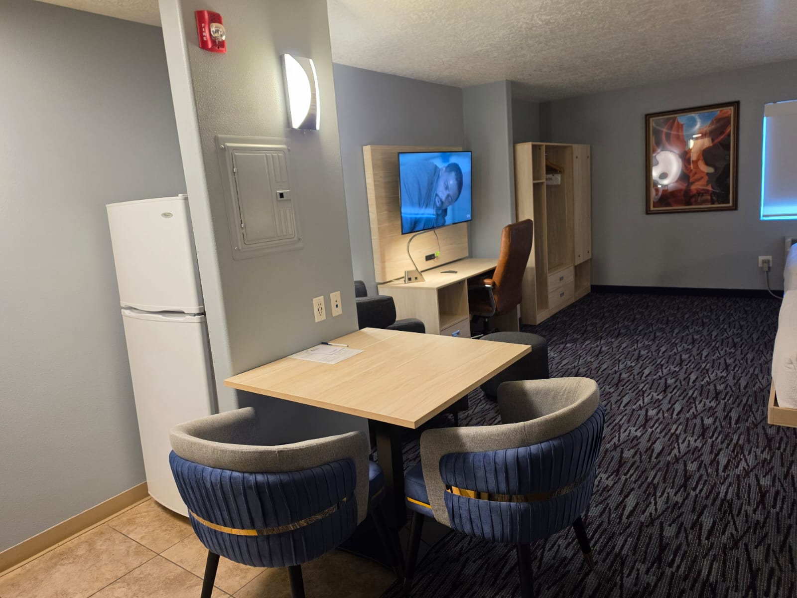 Dining table and full-height refrigerator in a studio room — Best Western Vernal Inn, Vernal Utah