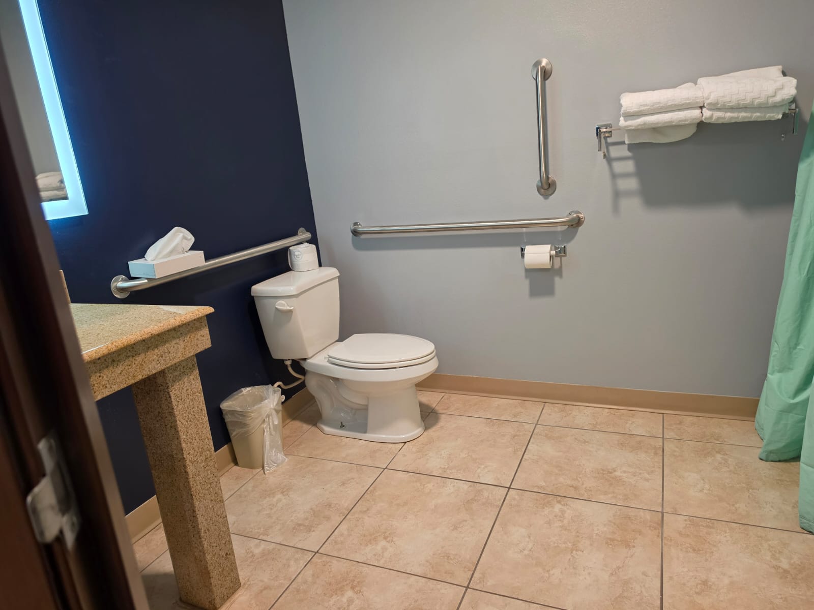 Accessible hotel bathroom with grab bars and open floor space between fixtures — Best Western Vernal Inn, Vernal Utah