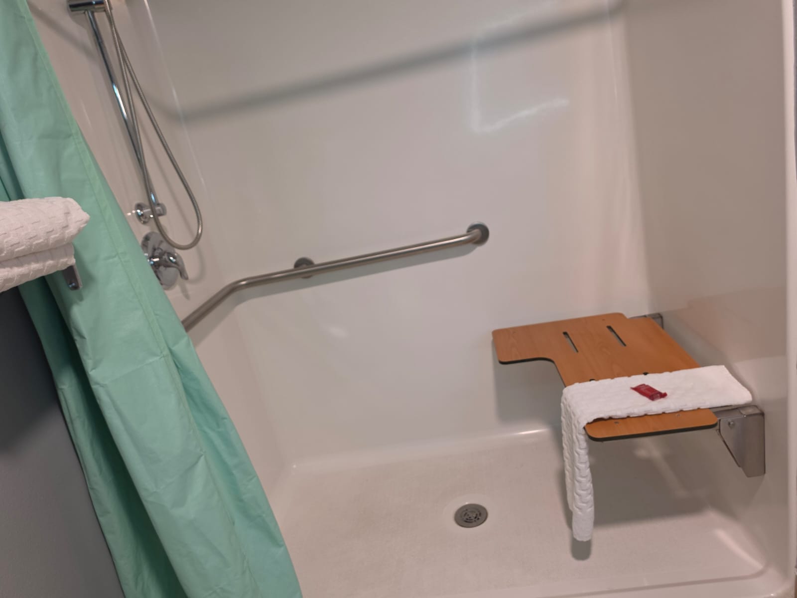 Accessible shower with handheld sprayer, slide bar and fold-down seat — Best Western Vernal Inn, Vernal Utah