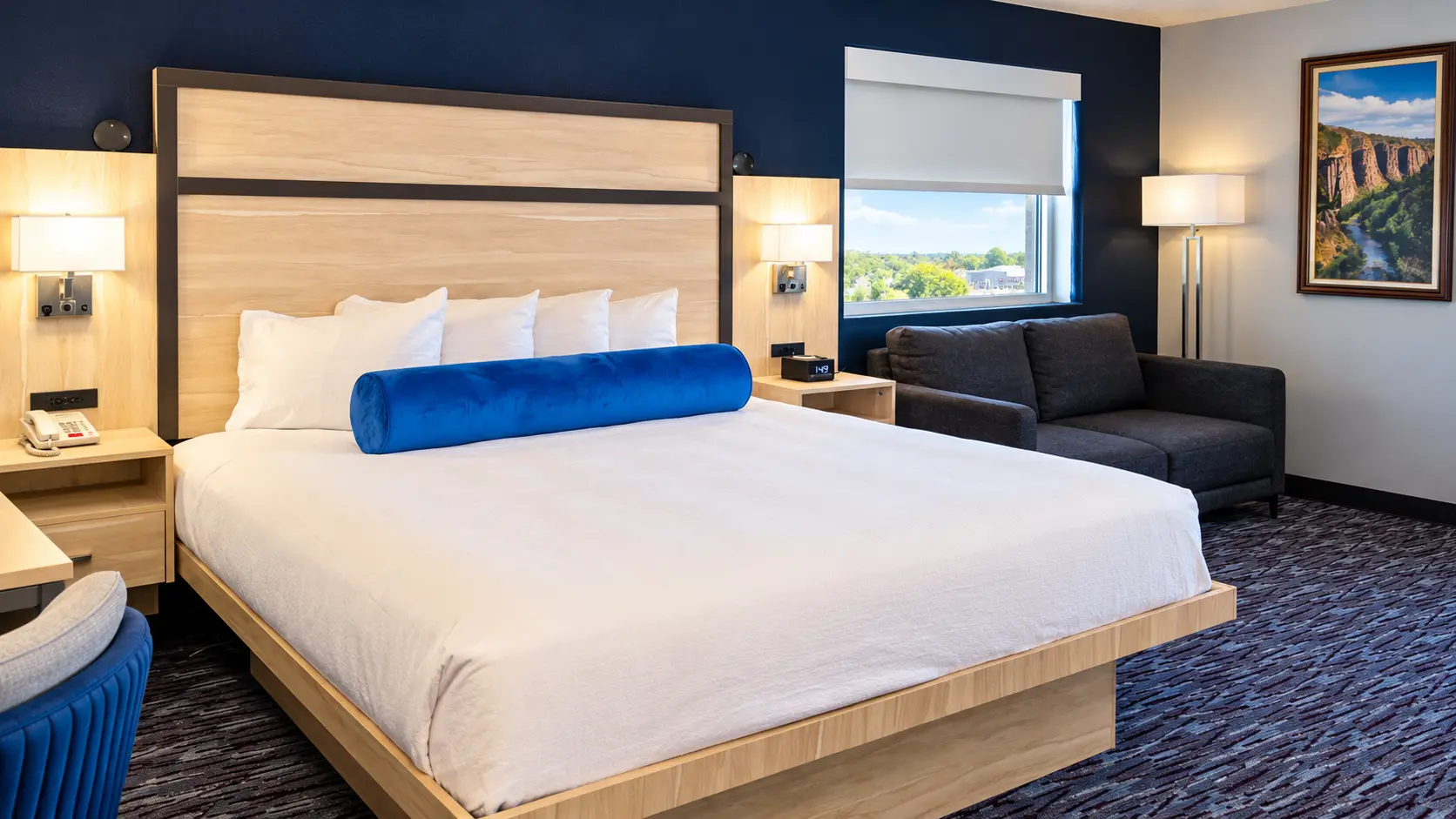 King bed beside a two-seat sofa and a window over Vernal — Best Western Vernal Inn, Vernal Utah