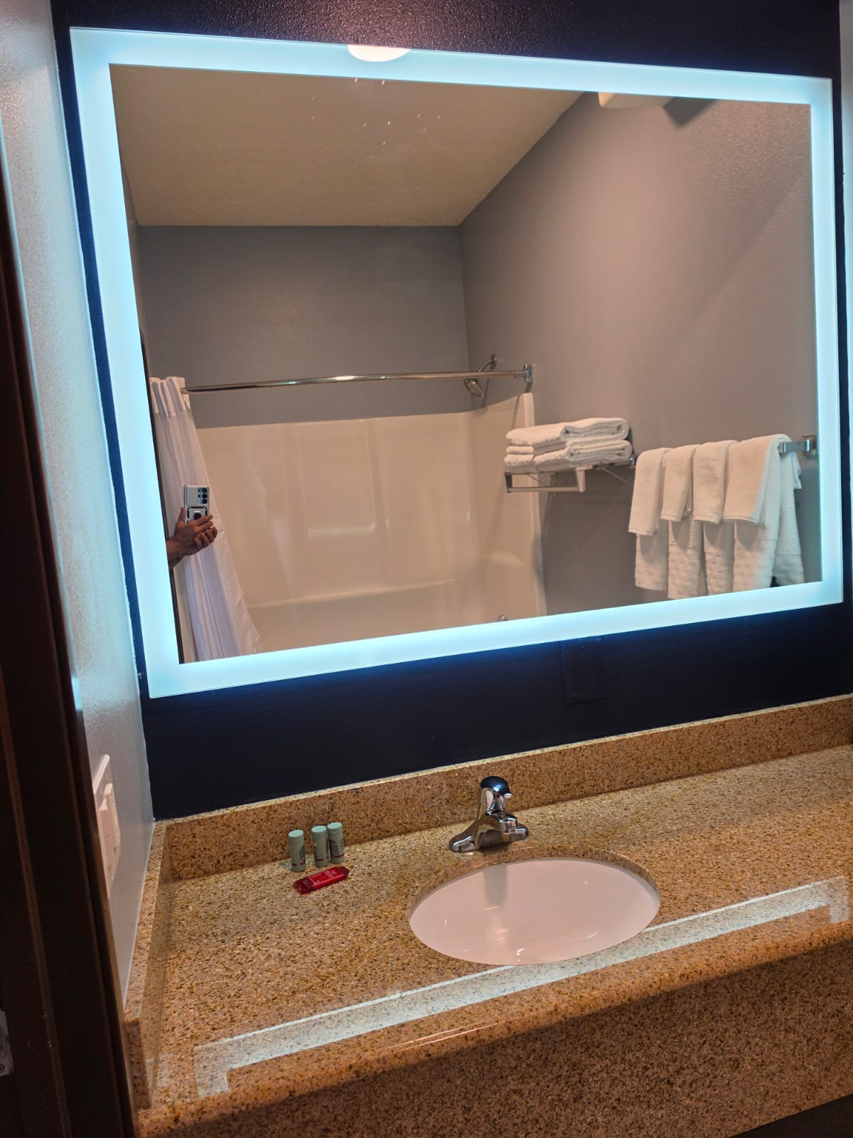 Bathroom vanity and backlit mirror reflecting the shower — Best Western Vernal Inn, Vernal Utah